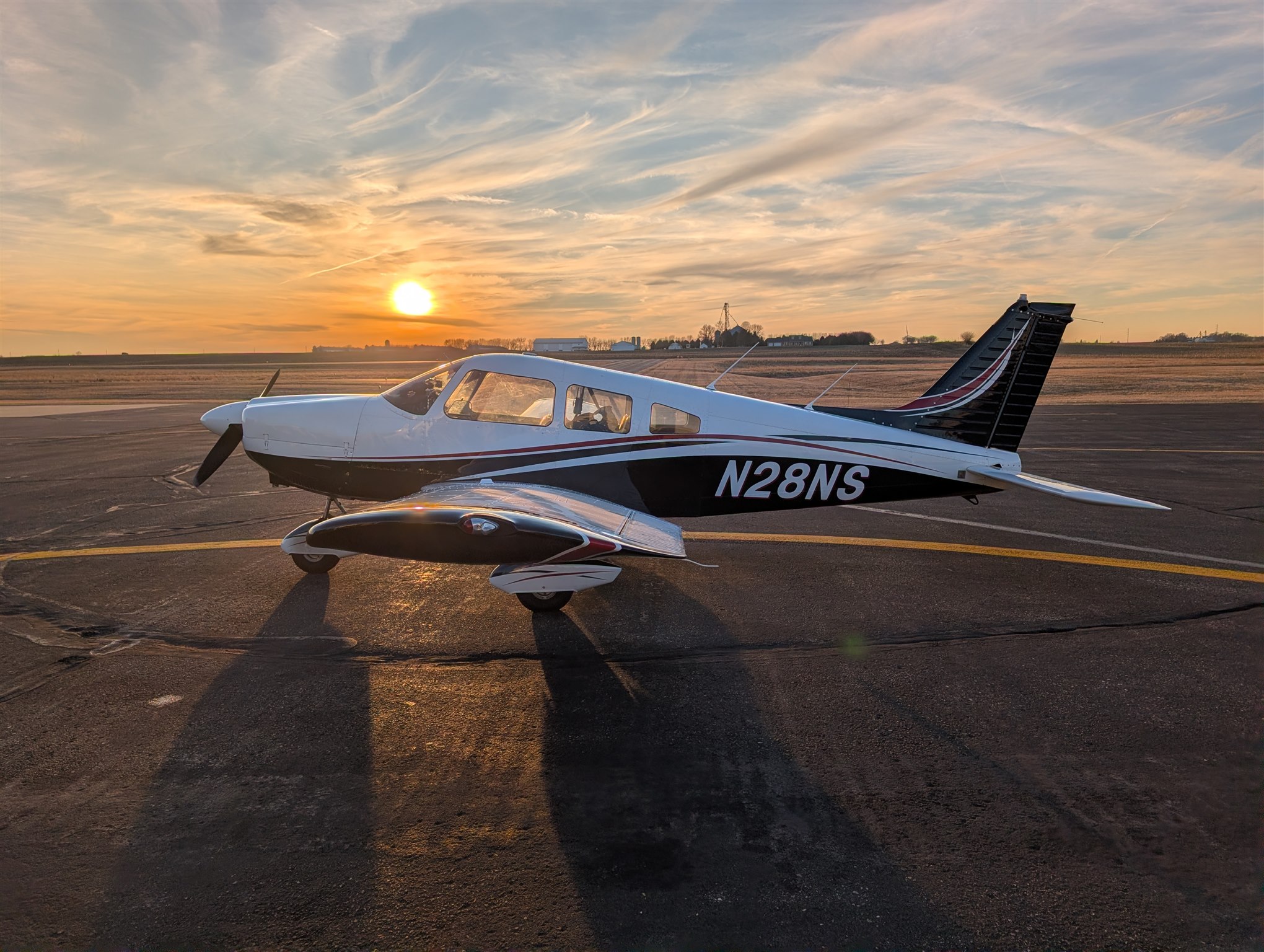 Piper Archer N28NS parked on the ramp at sunset