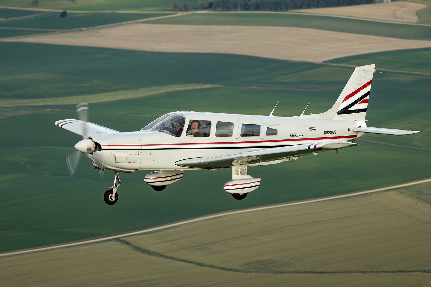 Mockingbird Flying Club's Piper Saratoga flying over farmland