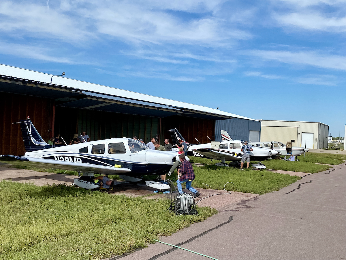 Club members washing airplanes outside the hangar