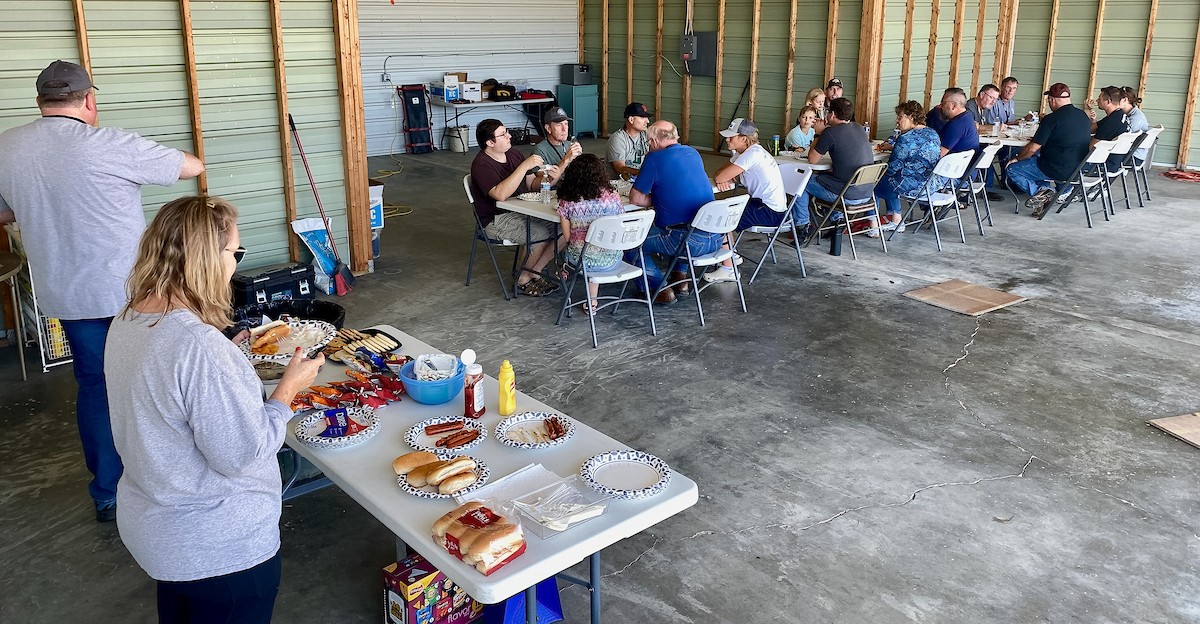 Club members sharing a meal in the hangar