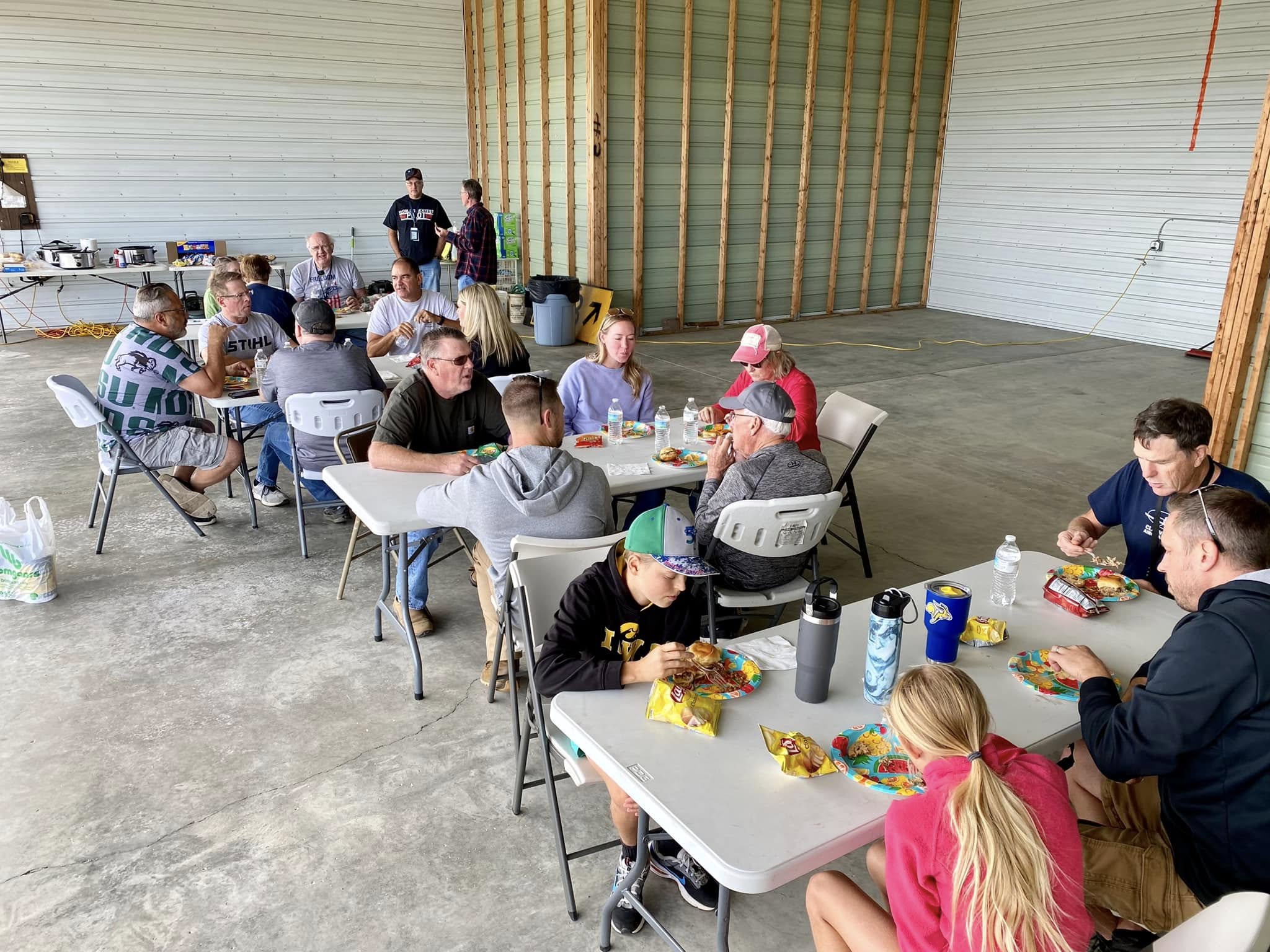 Club members and family sharing a meal in the hangar