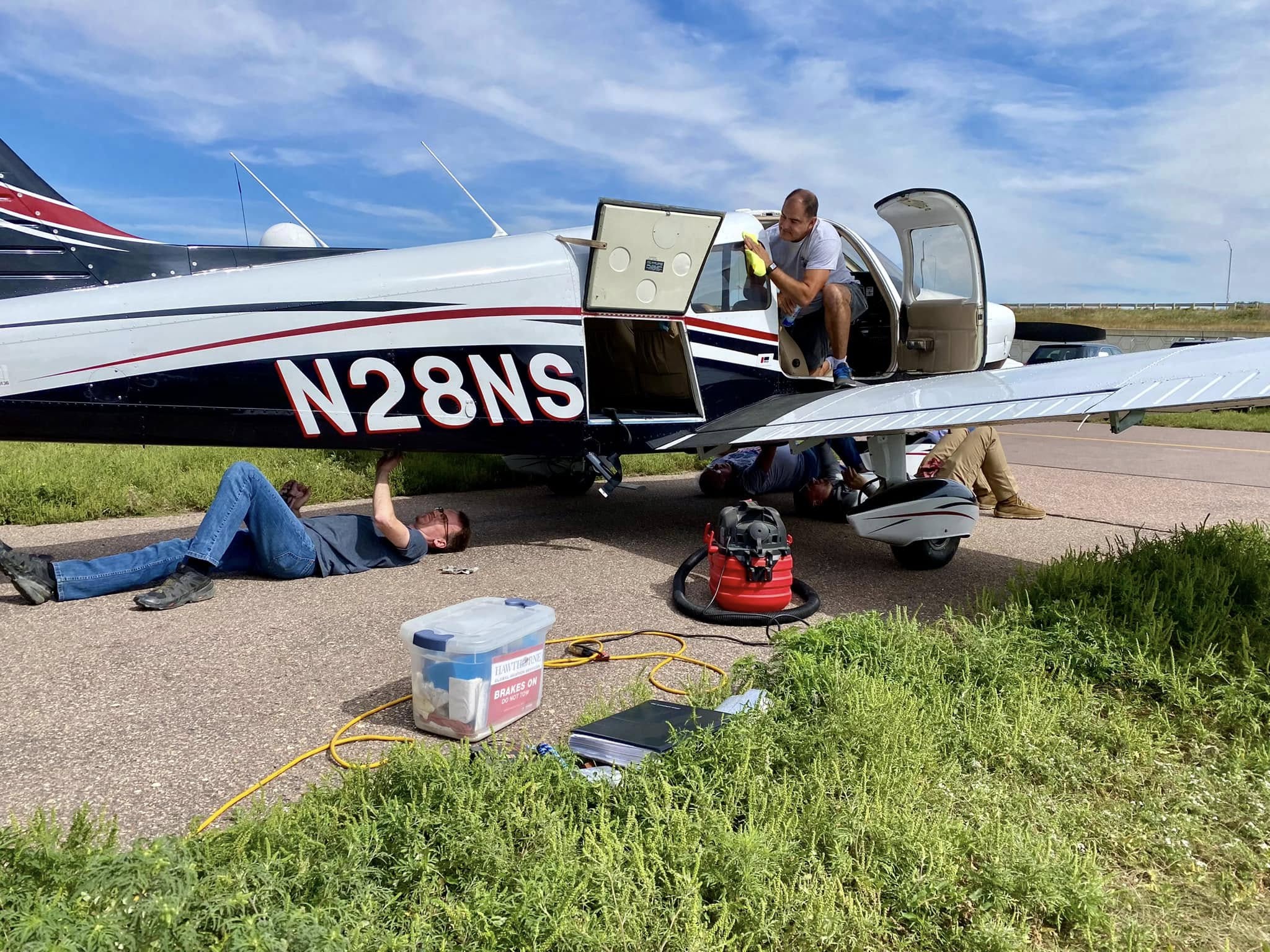 Club members washing N28NS on the ramp